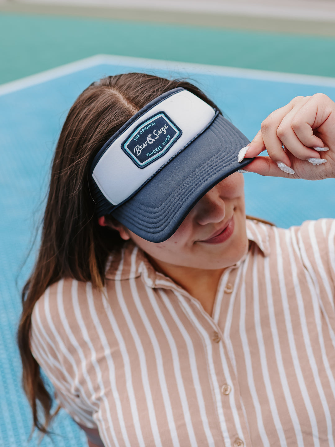 Woman wearing navy and white Retro B+S trucker visor on court — Bear & Sarge