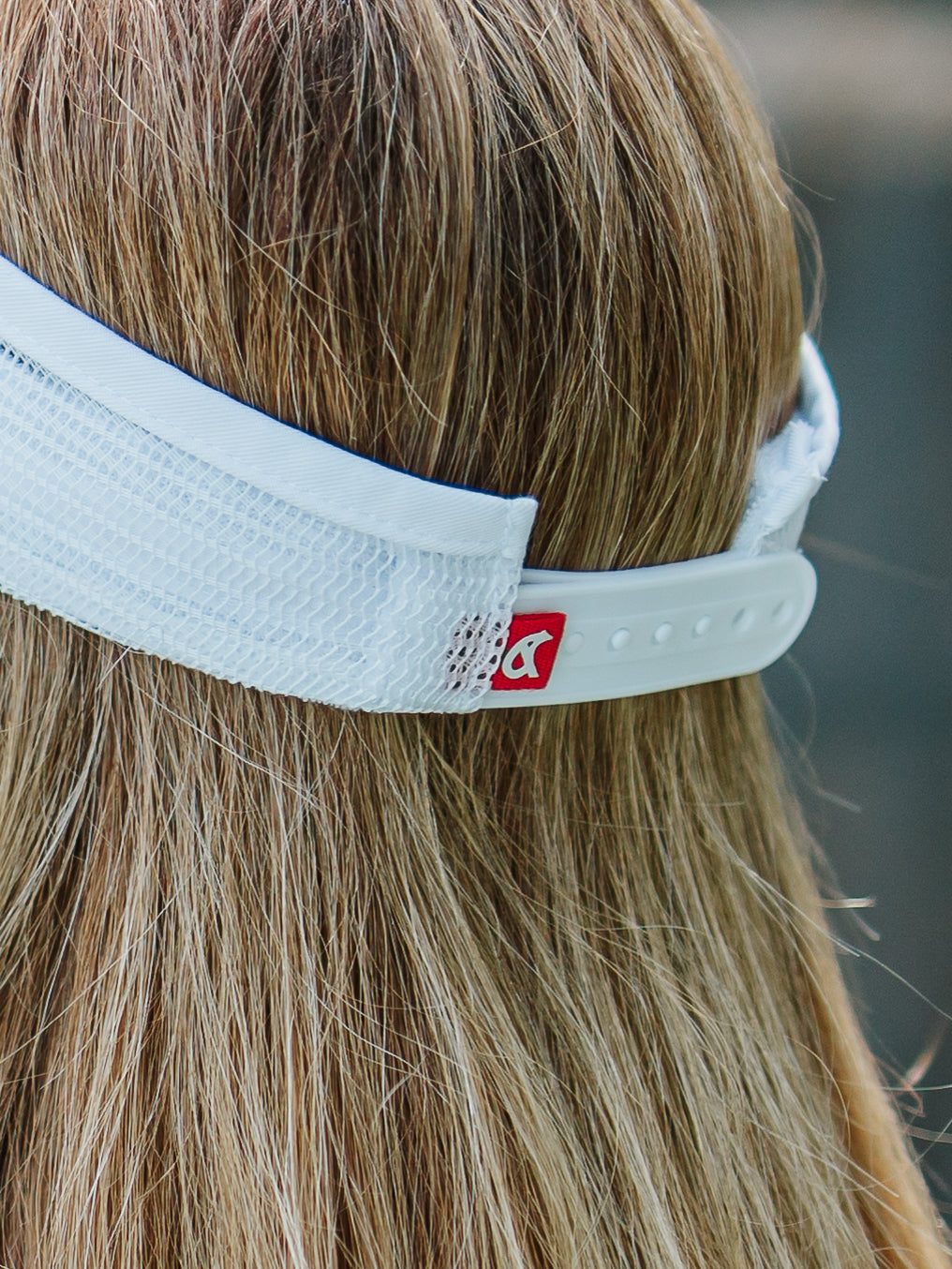 Back view of white Bear & Sarge visor snapback with red B+S tag